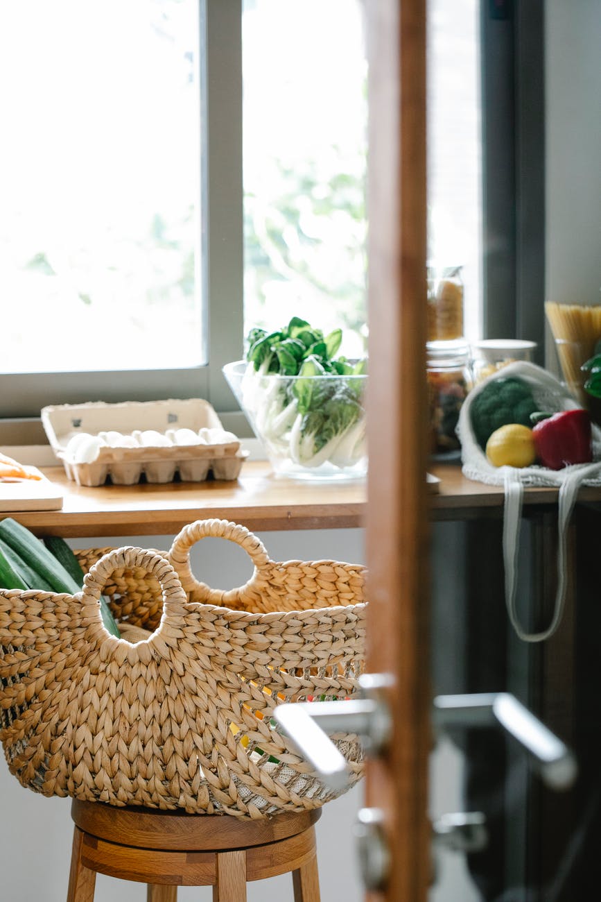 basket with vegetables on stool in kitchen