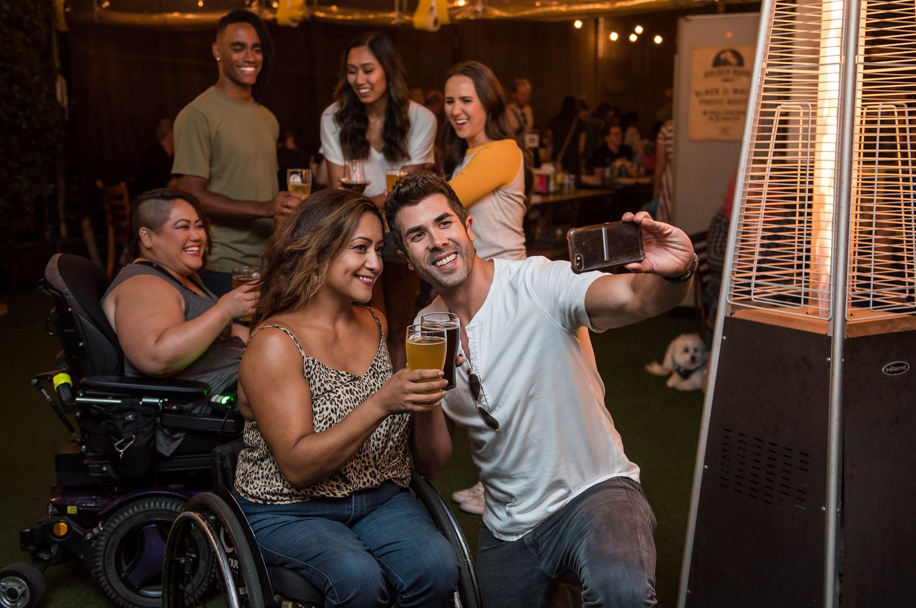 man taking photo with woman holding drink