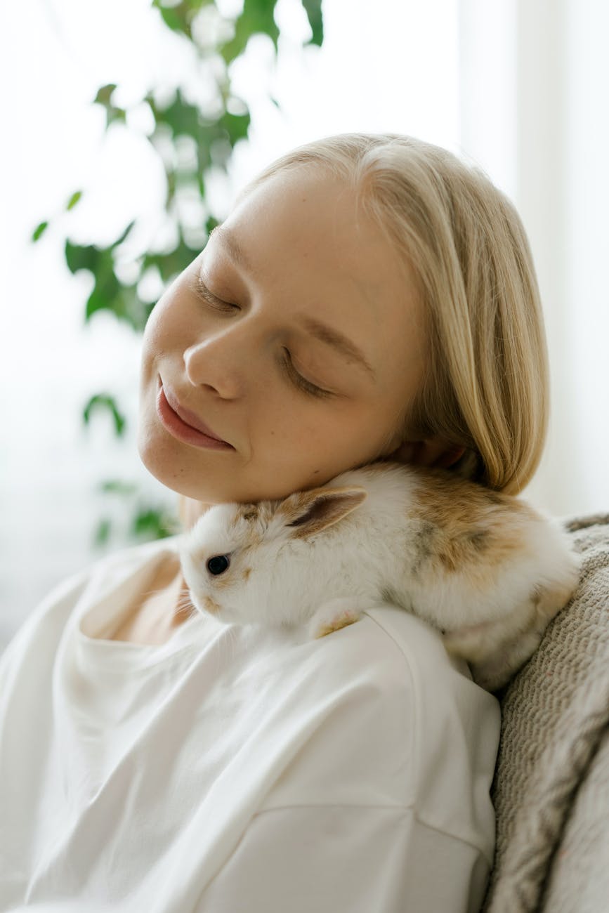 peaceful woman cuddling with bunny