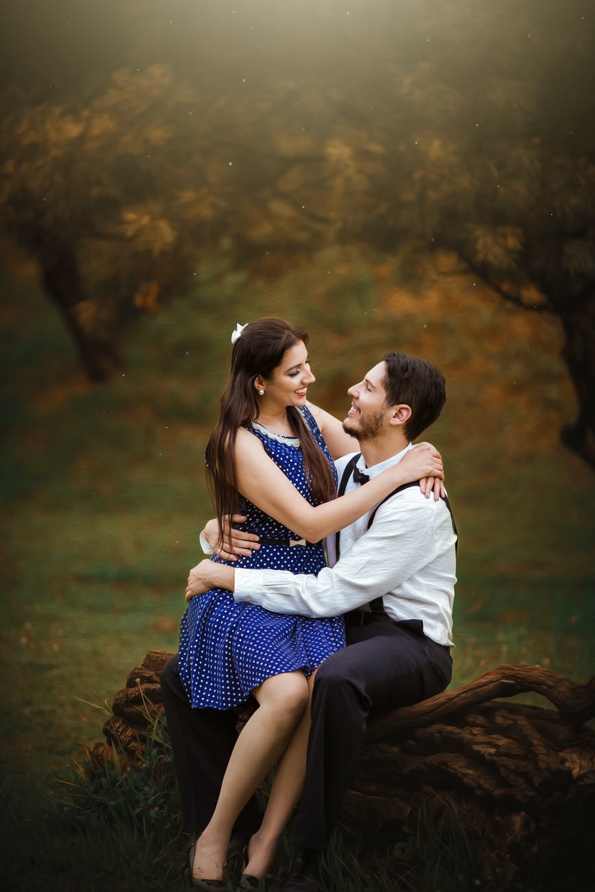 girl wearing blue dress sitting on man s lap