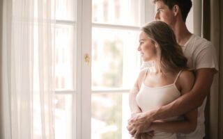 tender couple cuddling in living room at home