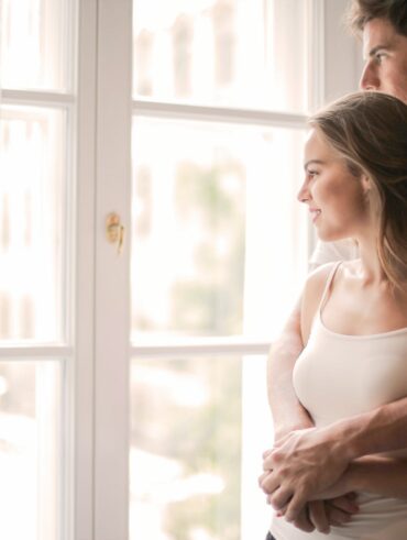 tender couple cuddling in living room at home