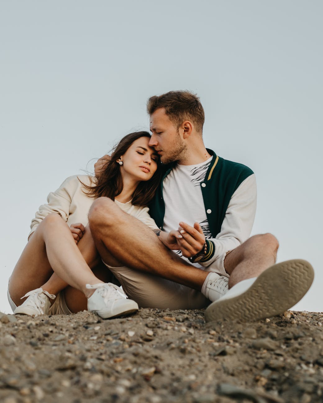 happy couple embracing on rocky terrain