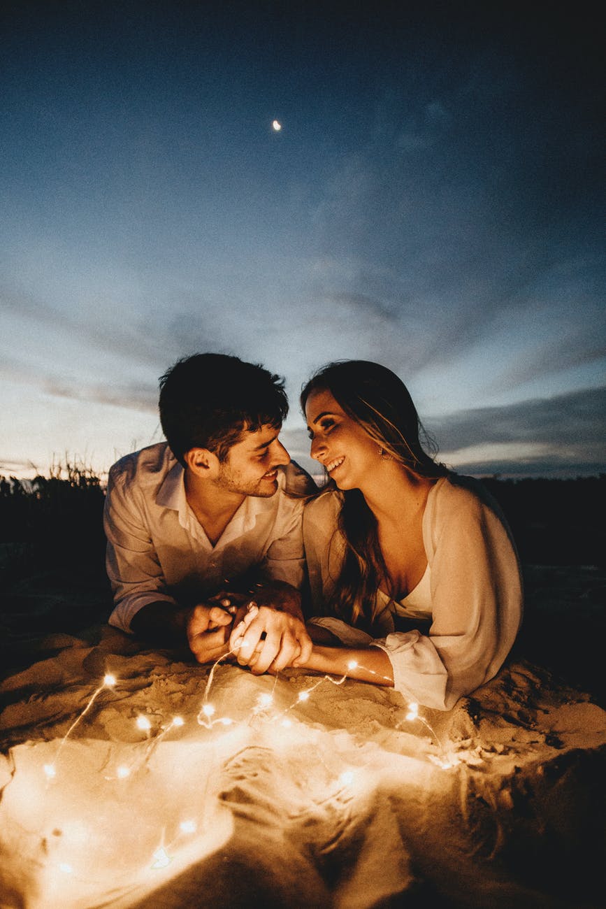 romantic couple holding hands in evening