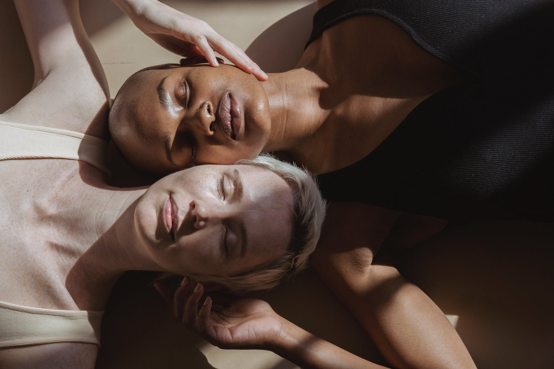 gentle multiracial models with closed eyes resting on floor